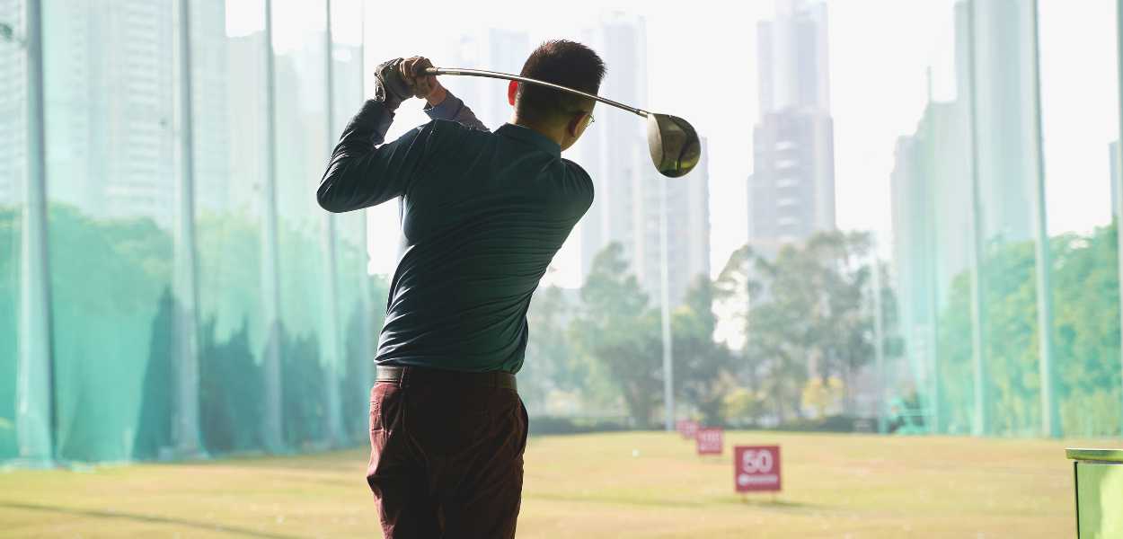 An avid golfer enjoying his swing. This article explores the most common golf injuries and how to prevent them.